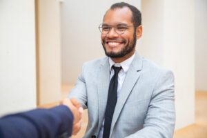 Cheerful business man greeting colleague